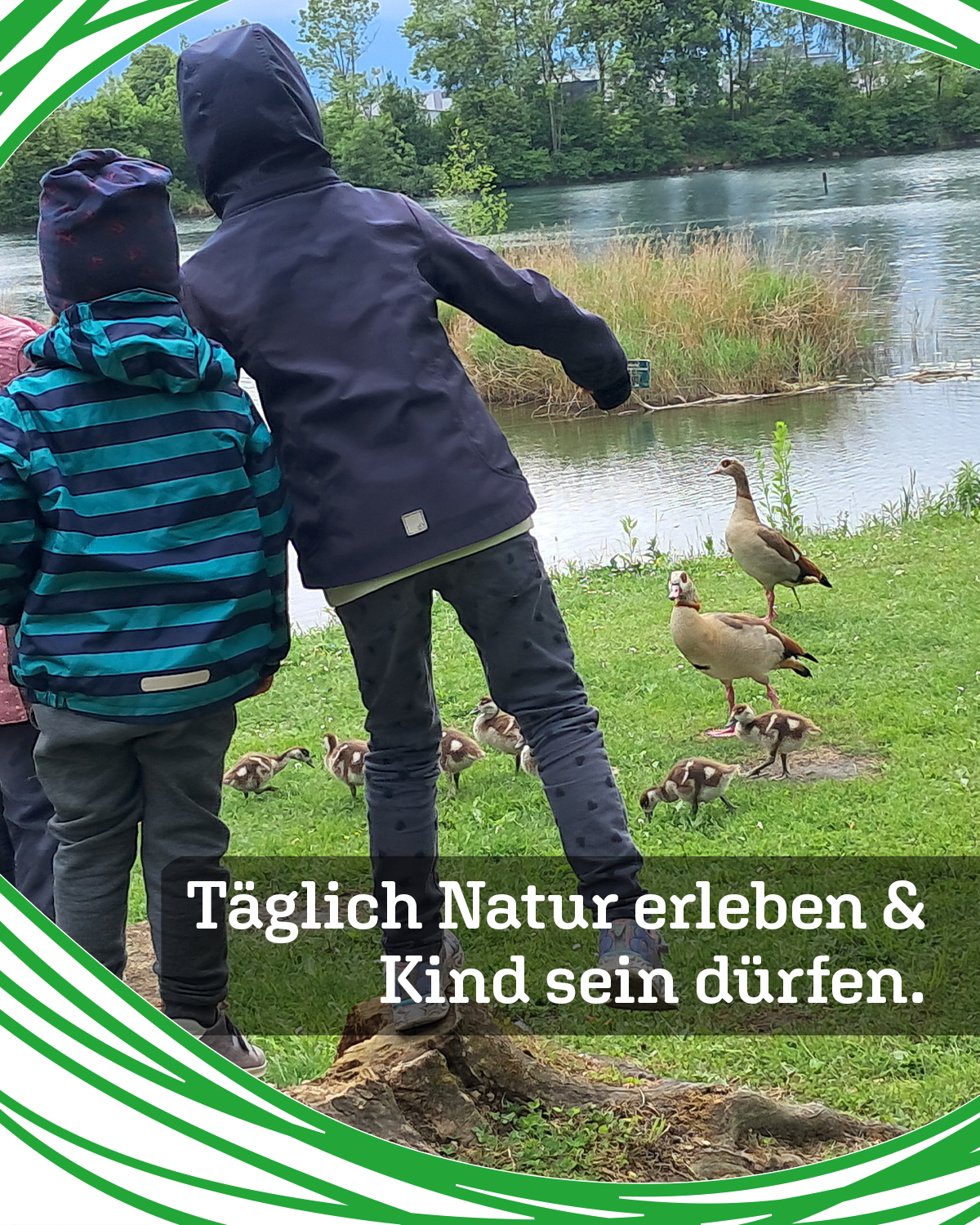 Children in jackets by a river feeding ducks and ducklings in a grassy park area with trees in the background by green decorative border.