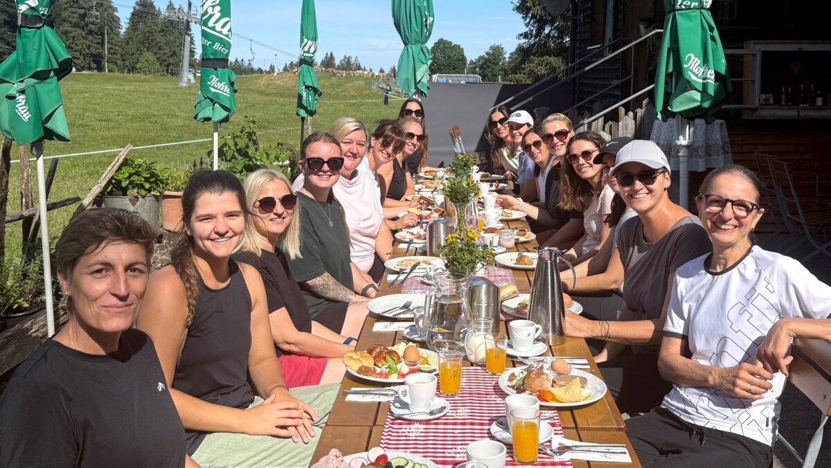 Unsere Zwergengarten-Leitungen sitzen am auf der Terrasse des Restaurants und lächeln in die Kamera. (c) KibeV